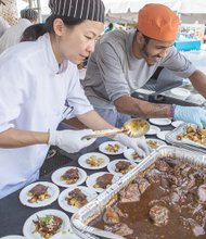 Caterers Ellie Basch and Jonah Rueda of Everyday Gourmet help satisfy appetites with a dish known as Isley’s Brewery Choosy Mothers Peanut Butter Porter braised short ribs on chili lime potato salad.