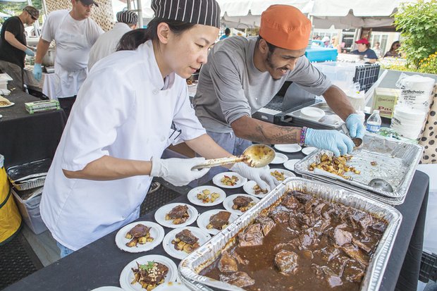 Caterers Ellie Basch and Jonah Rueda of Everyday Gourmet help satisfy appetites with a dish known as Isley’s Brewery Choosy Mothers Peanut Butter Porter braised short ribs on chili lime potato salad.