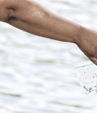 Vashon Williams, 3, has second thoughts about baiting his own hook as he watches his mother, Gloria, pull a worm out of a bag. People of all ages gathered to sink a line to take home more than a fish story.