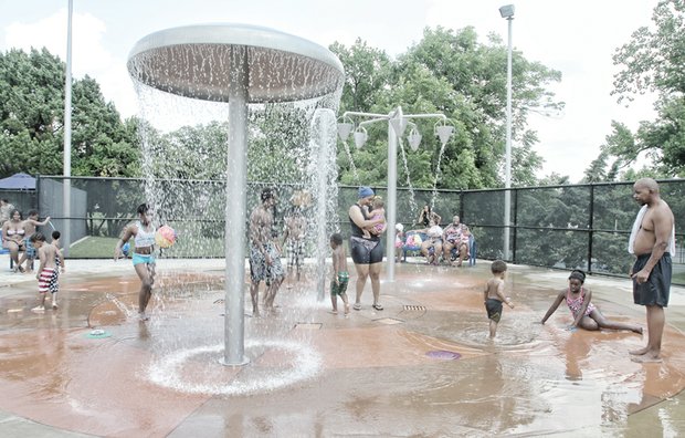Parents and children enjoy the splash pad area at Battery Park Pool on North Side — one of the city’s seven outdoor pools that opened during the weekend. The pools are popular places to cool off in the soaring summer heat. The pools are open seven days a week through Labor Day. The other six outdoor pools include Hotchkiss on North Side, Fairmount and Woodville in Church Hill, Powhatan in Fulton, Blackwell on South Side and Randolph in the near West End.