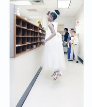 UPLIFTING LAST DAY-
A smiling Aniyah Rajab, 11, attracts attention as she jumps to wave goodbye to office staff at Linwood Holton Elementary School last Friday — the final day of public school classes in Richmond. All dressed up and ready to go, the fifth-grader, who will head to middle school this fall, was among the more than 23,000 city students who streamed out school doors into summer vacation.