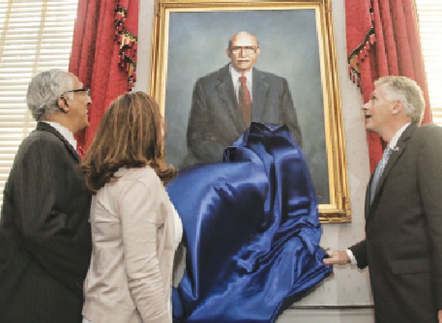 Gov. Terry McAuliffe, right, and his wife, Dorothy McAuliffe, are joined by Oliver W. Hill Jr., as they unveil a portrait of his father, legendary civil rights attorney Oliver W. Hill, at the Executive Mansion.