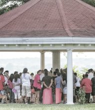 People gather Monday in Chimborazo Park in the East End to participate in a prayer vigil for the nine people who were murdered in Charleston, S.C.