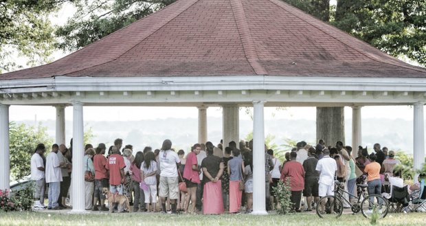 People gather Monday in Chimborazo Park in the East End to participate in a prayer vigil for the nine people who were murdered in Charleston, S.C.