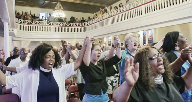 Worshippers sing “We Shall Overcome” at the unity rally at Third Street Bethel AME Church in Downtown last Friday to honor the South Carolina shooting victims