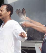 Danny Richardson of the Haliwa-Saponi Tribe in North Carolina uses sage to bless J. Ron Fleming in a Native American ceremony kicking off the event presented by the Elegba Folklore Society.