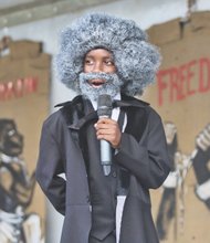 JUNETEENTH- Scores of people gathered on South Side last Saturday to celebrate Juneteenth, the day that commemorates the announcement of the abolition of slavery in Texas on June 19, 1865. Right, Elijah Coles Brown, a gifted 11-year-old orator from Henrico County who donned a wig, beard and period dress, recites Frederick Douglass’ famed “The Meaning of July Fourth for the Negro” speech. The speech attacked the hypocrisy of July 4th celebrations during times of enslavement. 
