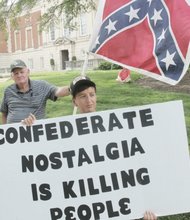 
Sydney Lester of the Virginia Flaggers carries the Confederate battle flag during his group’s protest last Saturday in front of the Virginia Museum of Fine Arts on the Boulevard. The museum has removed the symbol of hate from the Confederate Chapel located behind the museum. When the Virginia Flaggers were spotted, Camille Rudney and members of Justice 4 RVA arrived with their own signs in solidarity with Charleston, S.C., calling for the flag to be put away.