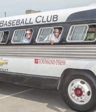 Frank J. Thornton, right, chairman of the Henrico County Board of Supervisors, and Supervisor Richard W. “Dick” Glover try out the bus the Anderson Monarchs rolled in on. It’s a replica of a 1947 Flxible Clipper like the one used by the Kansas City Monarchs. The only “air conditioning” comes from opening the windows.