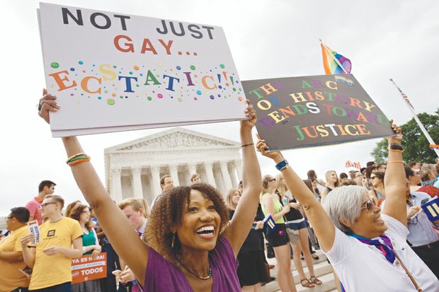 Ikeita Cantu, left, and wife Carmen Guzman celebrate outside of the Supreme Court in Washington after a 5-4 majority ruled last Friday that same-sex couples have a constitutional right to marry. 