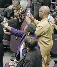 Audience members capture poignant moments on their cell phones during the homegoing service for Maggie Ingram, the revered gospel performer who led Maggie Ingram and The Ingramettes for more than six decades.