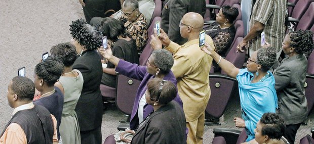 Audience members capture poignant moments on their cell phones during the homegoing service for Maggie Ingram, the revered gospel performer who led Maggie Ingram and The Ingramettes for more than six decades.