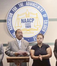 ON HER SIDE- Kandise Lucas, a volunteer advocate for schoolchildren with mental challenges, receives a pledge of state NAACP support Monday from Jack Gravely, interim executive director of the civil rights group. Location: The state NAACP headquarters in Richmond. The state NAACP rallied to assist Ms. Lucas after she was arrested in May for trespassing at a Chesterfield County school from which she was barred. She was handcuffed after she showed up to serve as an advocate for a special needs child at the request of the child’s parents. Ms. Lucas chose not to fight the charge in court Tuesday. She entered an Alford plea in which she maintained her innocence, but agreed the evidence was strong enough to convict her. She was placed on 12 months’ probation, with the prospect the charge could be dismissed if she is not arrested or convicted again.