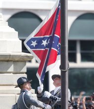 A South Carolina Highway Patrol honor guard removes the Confederate flag from the Columbia statehouse grounds during a ceremony witnessed by thousands.