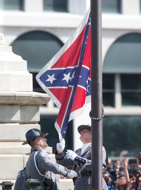 A South Carolina Highway Patrol honor guard removes the Confederate flag from the Columbia statehouse grounds during a ceremony witnessed by thousands.