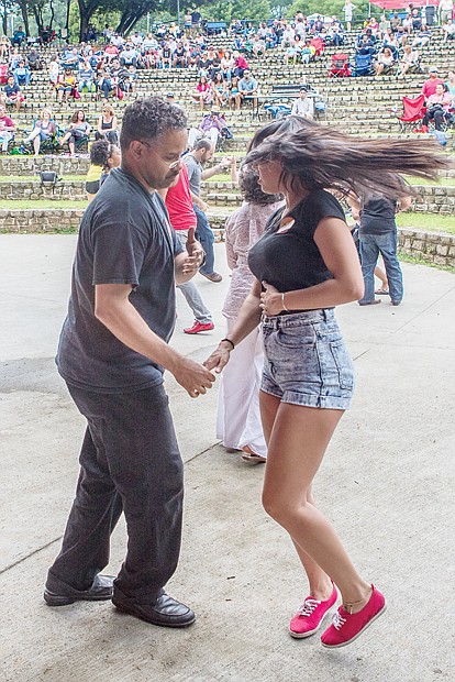 RHYTHM OF THE BEAT- The rhythmic sounds of Latin jazz filled the air last Saturday at Dogwood Dell in Byrd Park as dancers twirled and twisted at the 8th Annual Latin Jazz and Salsa Festival. A slew of performers, dancers and jazz musicians inspired the dancers — young and old — to show off their fancy footwork. Michael Douglas and Giuliana Roggiero.