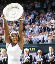 Wimbledon champion Serena Williams holds high the Venus Rosewater Dish trophy she was awarded after clinching the women’s singles final last Saturday. She also received a $2.9 million prize.