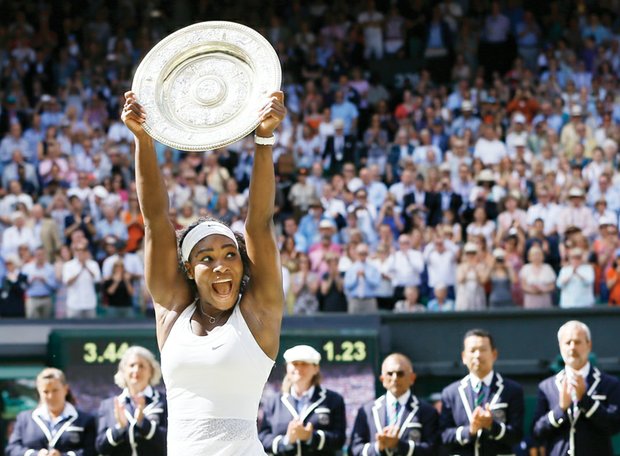 Wimbledon champion Serena Williams holds high the Venus Rosewater Dish trophy she was awarded after clinching the women’s singles final last Saturday. She also received a $2.9 million prize.