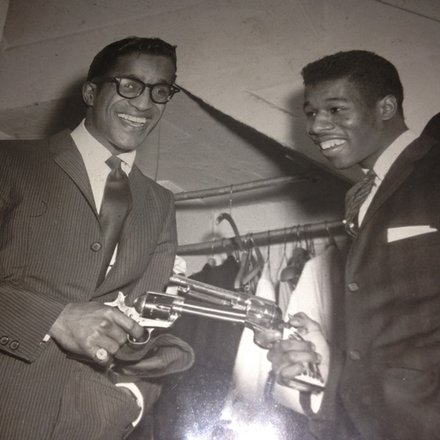 Elshabazz has fun with Sammy Davis Jr. and Davis' guns at night club.