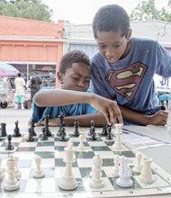 PAST, PRESENT COME TOGETHER AT HISTORY FESTIVAL - Caleb Penn, left, gets assistance from Khiri Nichols in planning his next chess move.