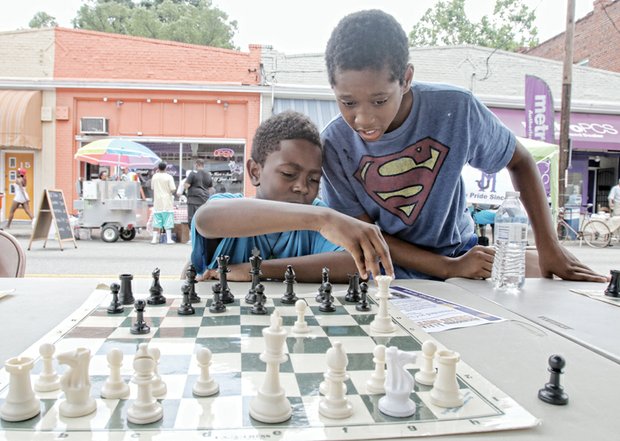 PAST, PRESENT COME TOGETHER AT HISTORY FESTIVAL - Caleb Penn, left, gets assistance from Khiri Nichols in planning his next chess move.
