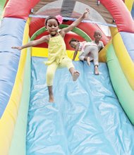 ONE GIANT LEAP-
All eyes are on 3-year-old Gabrielle Ba as she sails through the air and down a slide. She and her playmates were having fun Saturday at the 2nd Annual Brookland Park Boulevard History Festival on North Side. The free community event attracted hundreds of people and included entertainment, a farmer’s market, health screenings and lots of food and fun. Please see additional photos on B1.