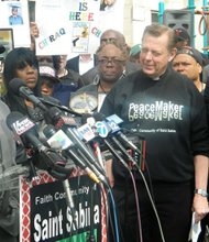 Filmmaker Spike Lee, the Rev. Michael Pfleger, pastor at St. Sabina Catholic Church on Chicago's South Side and actor John Cusack during a news conference earlier this year.
