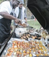 NORTH SIDE REUNION- Ronald Mayo, left, and Kelvin Barnes grill scrumptious food