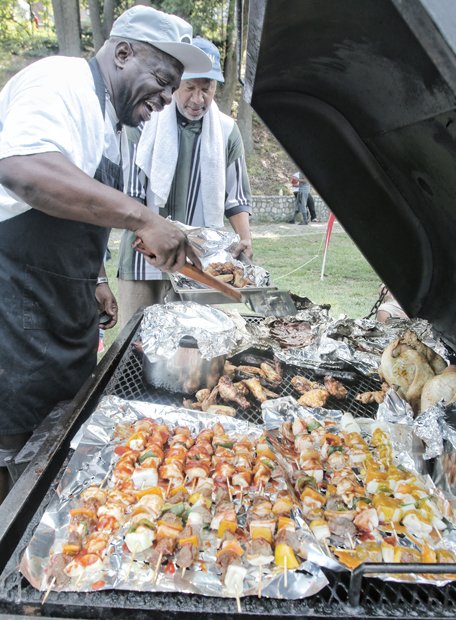 NORTH SIDE REUNION- Ronald Mayo, left, and Kelvin Barnes grill scrumptious food