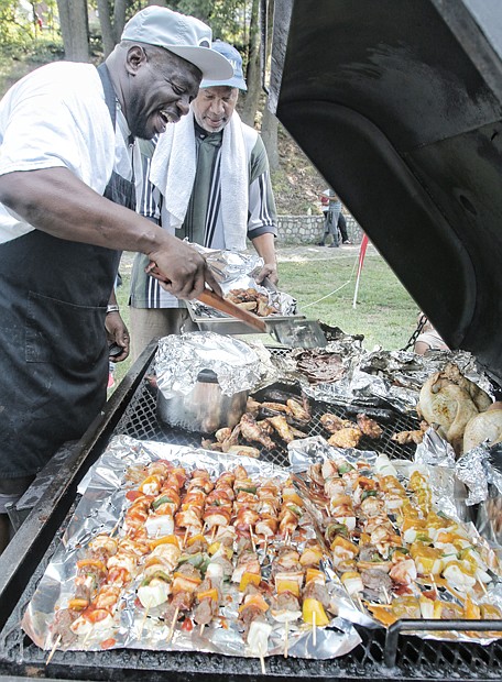 NORTH SIDE REUNION- Ronald Mayo, left, and Kelvin Barnes grill scrumptious food