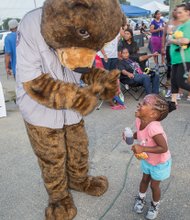 Food, fun and games for National Night Out- Hundreds of people gathered for food, fun and games at the National Night Out event Tuesday night at the Southside Community Center and Sports Complex, 6255 Old Warwick Road. It was one of dozens of events throughout Metro Richmond and across the nation held during the annual August event, which is designed to strengthen ties between citizens and law enforcement. Ayah Yates, 4, shows her delight as she interacts with Care Bear. 