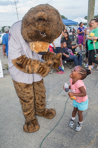 Food, fun and games for National Night Out- Hundreds of people gathered for food, fun and games at the National Night Out event Tuesday night at the Southside Community Center and Sports Complex, 6255 Old Warwick Road. It was one of dozens of events throughout Metro Richmond and across the nation held during the annual August event, which is designed to strengthen ties between citizens and law enforcement. Ayah Yates, 4, shows her delight as she interacts with Care Bear. 