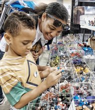 Brandon Jones and his sister, shanea Mercer, of Newport News gaze at action figures saturday at Wizard World Comic Con Richmond. the multi-genre entertainment and comic convention attracted elaborately costumed fans and others to the three-day event at the Greater Richmond Convention Center in Downtown. several celebrities also participated. 