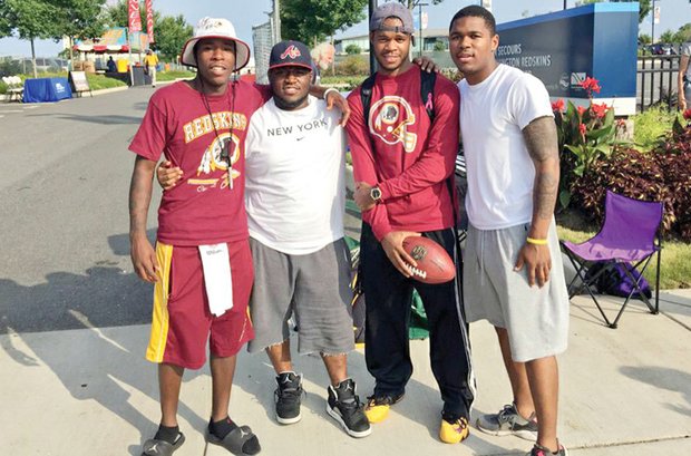 Longtime friends, left to right, TreVon Cannon, Keshaun Smoot, Marquis Richardson and Daryl Johnson were the first fans into the Washington professional football team’s training camp for three years running.