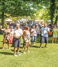 Music, food and fun - Festivalgoers perform a line dance Saturday at the 7th Annual Jazz & Food Festival at
St. Elizabeth Catholic Church in Highland Park.