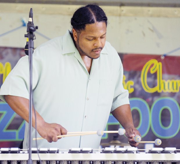 Music, food and fun - Curvey Reid with Curv Appeal playsthe vibraphone. The event blends food
and traditional and contemporary jazz with raffles, games and other activities.