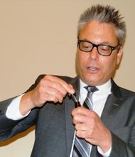 Andrew Deangelo of Illinois Grown Medicine LLC displays a small (mock) bottle of medical marijuana during a Chatham Business Association meeting.