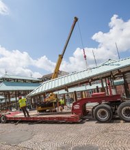 A crew from Pryor Hauling removes the roof of a shed Tuesday at the historic 17th Street Farmers’ Market.