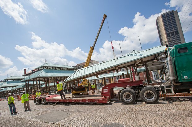 A crew from Pryor Hauling removes the roof of a shed Tuesday at the historic 17th Street Farmers’ Market. 