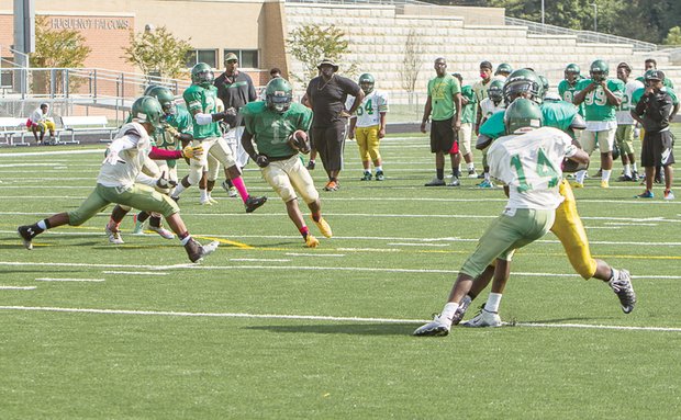 
Huguenot Falcons work on offense and defense as they prepare to welcome Thomas Jefferson for the first home game on their new field Saturday.