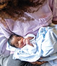 A mother cuddles her newborn before a city social worker arrived to take the baby. 
