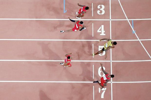 Overhead view shows Jamaican Usain Bolt (lane 5) edging American Justin Gatlin (lane 7) to claim 100-meter crown at the World Championships in China. This was Bolt’s third world title.