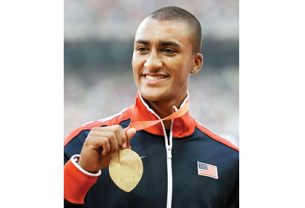 American athlete Ashton Eaton shows off his gold medal in the decathlon last Sunday at the IAAF World Championships at the Bird’s Nest stadium in Beijing.