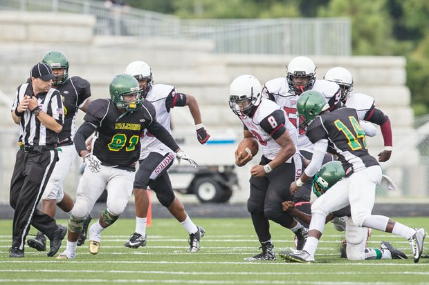 Huguenot linebacker Jameko Coleman (left, No. 81) goes after a Thomas Jefferson High School receiver during Saturday’s season opener at the new Huguenot football stadium. Huguenot beat Thomas Jefferson 14-0