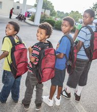 From left, Jandre, Nasir, Seneca and Jason Hackett are ready for the start of school with new book bags filled with school supplies. 