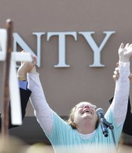 Kim Davis, Rowan County clerk, cries after her release Tuesday from the Carter County Detention Center in Kentucky. She met a crowd of supporters with GOP presidential candidate Mike Huckabee, left, and Mathew D. Staver of Liberty Counsel, the Christian law firm representing her.