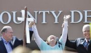 Kim Davis, Rowan County clerk, cries after her release Tuesday from the Carter County Detention Center in Kentucky. She met a crowd of supporters with GOP presidential candidate Mike Huckabee, left, and Mathew D. Staver of Liberty Counsel, the Christian law firm representing her.