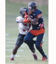 Virginia State University wide receiver Jaivon Smallwood (No. 80) is nabbed and stopped by Devonte Suber of California University of Pennsylvania.