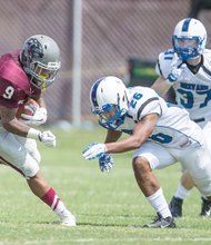 Virginia Union University freshman Hakeem Holland gets the ball past Brevard College opponents at Hovey Field, helping the Panthers to a 35-21 opening victory.  