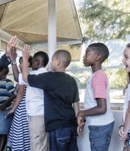 High-five for the new school year-Richmond Public Schools Superintendent Dana T. Bedden greets third-graders at J.B. Fisher Elementary School on South Side with high-fives on Tuesday, the first day of school. RPS officials reported a mostly smooth back-to-school launch for the nearly 24,000 students in pre-kindergarten through 12th grades. 
